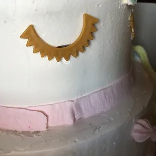 a white cake with pink icing