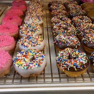 a variety of doughnuts in a display case