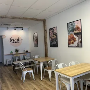 a dining room with a wooden table and white chairs