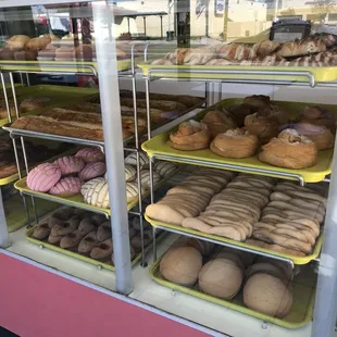 a variety of doughnuts in a display case