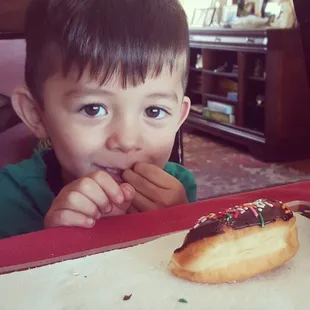 My nephew enjoying sprinkle doughnuts.