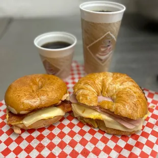 a croissant sandwich and a cup of coffee