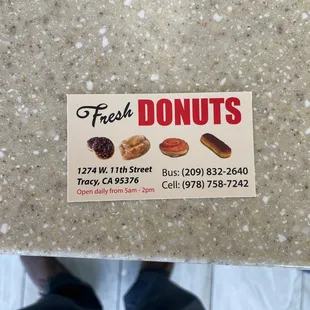 a person standing in front of a box of donuts