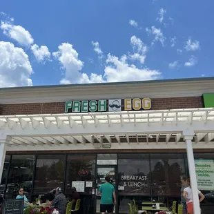 people standing outside of the restaurant