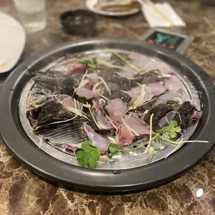 a plate of raw fish on a table