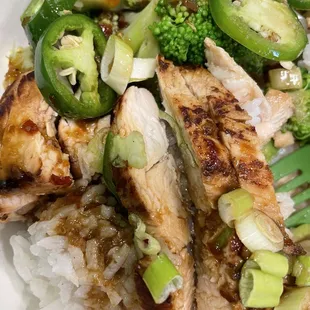 a plate of chicken, broccoli, and rice