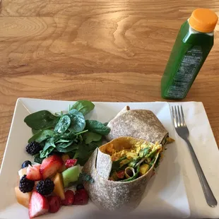 a burrito, fruit, and salad