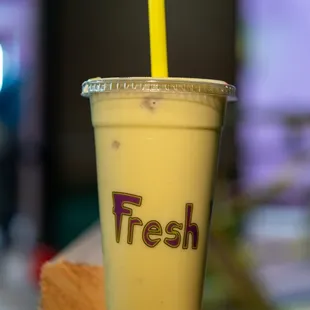 a yellow cup with a straw