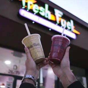 two people holding drinks