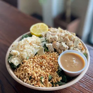 a bowl of food with a side of sauce