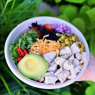 a person holding a bowl of food