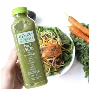 a person holding a bottle of juice