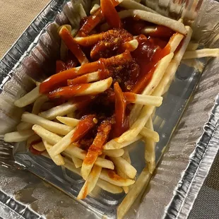 Undercooked fries smothered in ketchup and salsa
