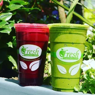 two green and red smoothie cups