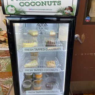 a display of fresh tapped coconuts