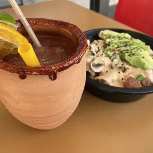 a drink with a garnish and a slice of orange