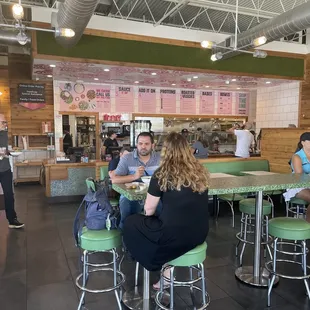a group of people eating at a restaurant