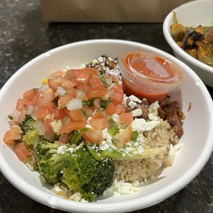 Brown rice and spice rice for the base, blackened chicken for protein, broccoli for veggies. I added feta cheese and salsa.