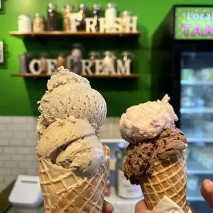 two people holding ice cream cones