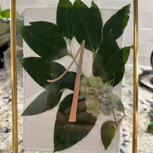 Table Numbers with gold paint, torn Deckled edge paper and fresh greenery