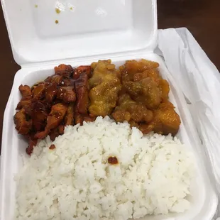 a takeout box of rice, chicken, and beans
