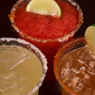 three margaritas with lime wedges