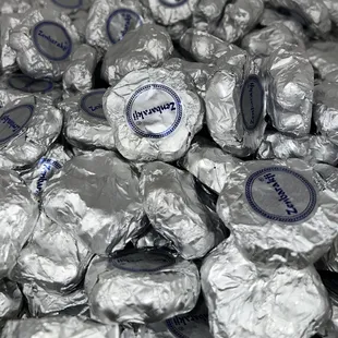 a pile of foil wrapped chocolates