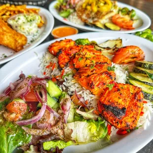Chicken Kabob entree:
 Basmati rice, veggies, salad and garlic sauce