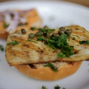 Grilled wild mahi on a brioche slider bun with Krazy FOB sauce, capers and onions.