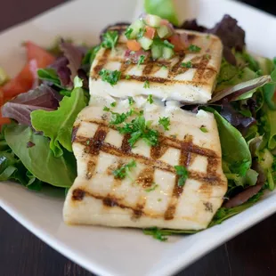 Mahi salad, with romaine, red leaf, cucumbers, tomatoes onions and roasted corn. Dressing choices - lemon oregano, balsamic or soy ginger