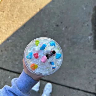 a person holding a cup of ice cream