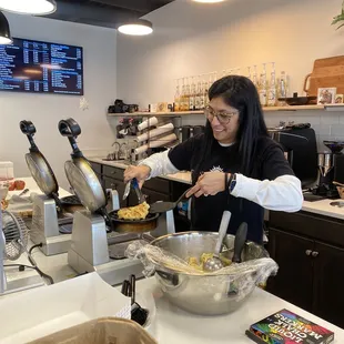 a woman mixing food in a bowl