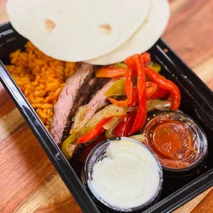 Carne Asada Tacos - marinated steak, tomatillo, cilantro, avocado crema, manga salsa served with Mexican cauliflower rice.