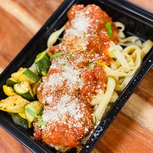Spaghetti &amp; Meatballs - pasta served with pork and beef meatballs in a savory marinara sauce. Topped with parmesan cheese and basil.