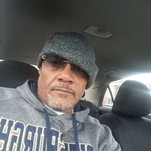 a man sitting in the back seat of a car