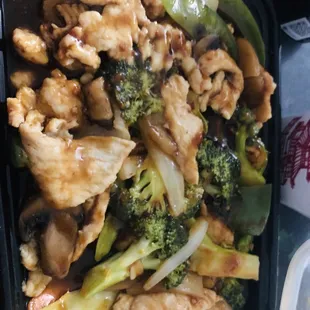 chicken, broccoli, and other vegetables in a plastic container