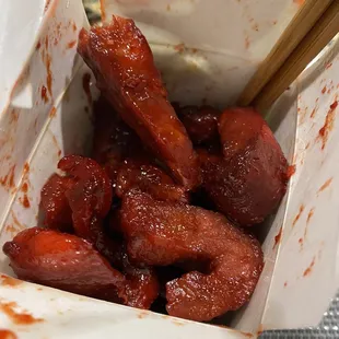 hot dogs in a paper container with chopsticks