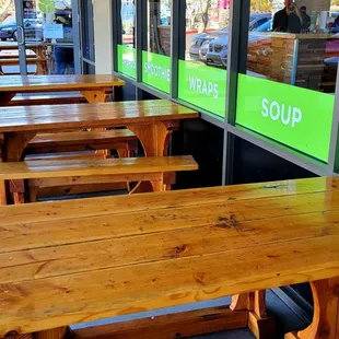 a row of wooden picnic tables