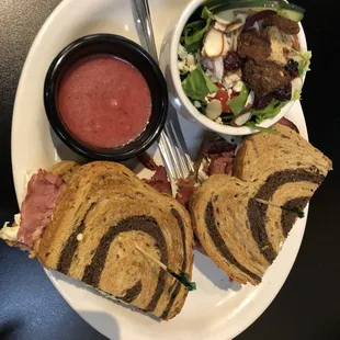 Pastrami and rye sandwich with a sunshine side salad