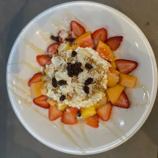 a plate of fruit and ice cream