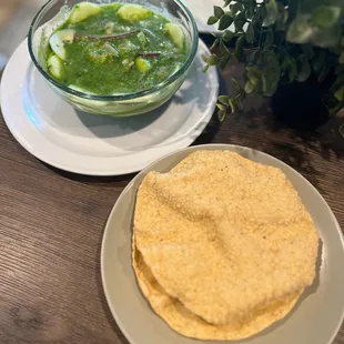 a plate of tortilla and a bowl of salsa