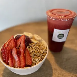 a bowl of granola, strawberries, and a smoothie