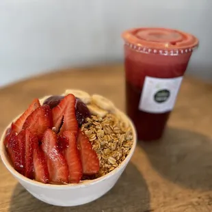 a bowl of granola with strawberries and a smoothie