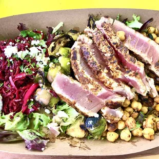 Mixed Green Salad Bowl with fresh seared tuna, roasted brussel sprouts, beets, feta and crispy fried garbanzos with a balsamic dressing!