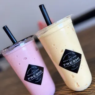 two smoothie drinks on a table