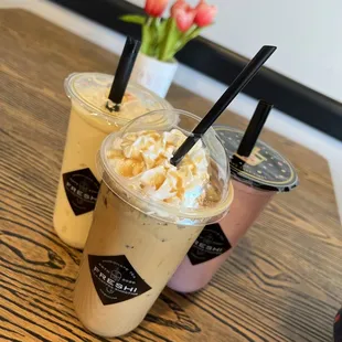 two cups of iced coffee on a wooden table