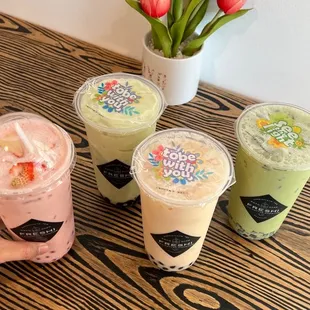 a variety of smoothie drinks on a table