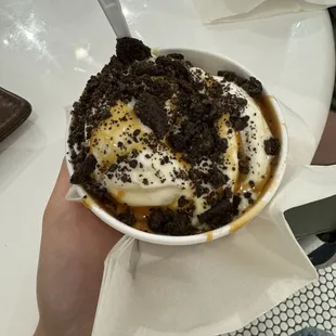 Scoop of vanilla with caramel sauce and Oreo crumbs