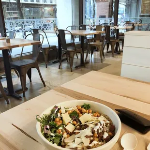 a bowl of salad on a table in a restaurant