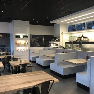 the inside of a restaurant with tables and chairs